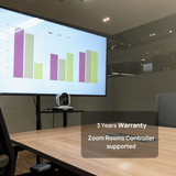 Atiroh PTZ conference camera installed in a meeting room setup with display screen showing a graph, featuring Zoom Rooms controller support and 3-year warranty.